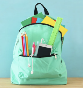 Small green backpack filled with school supplies